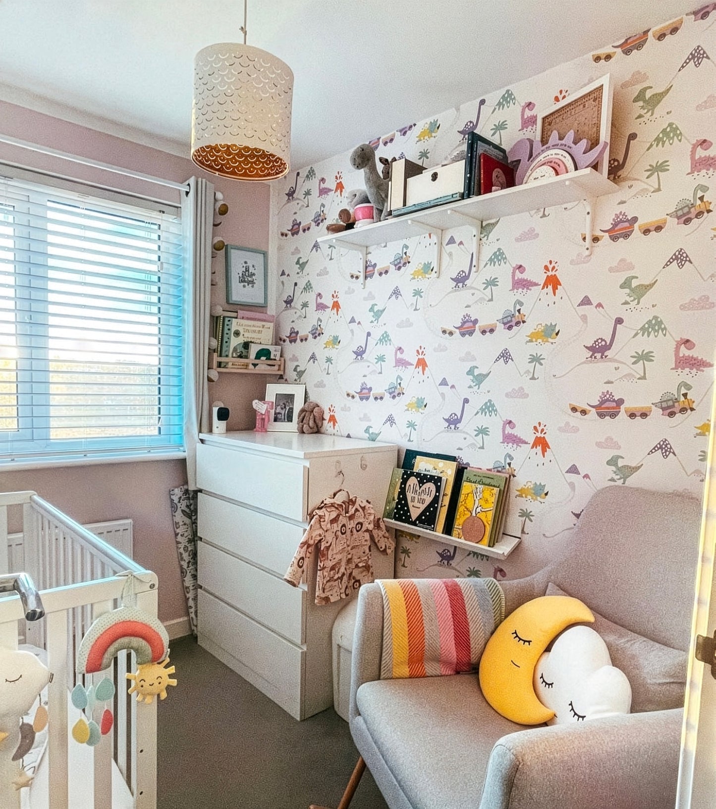 Children's bedroom with colorful wallpaper, shelves, and toys.