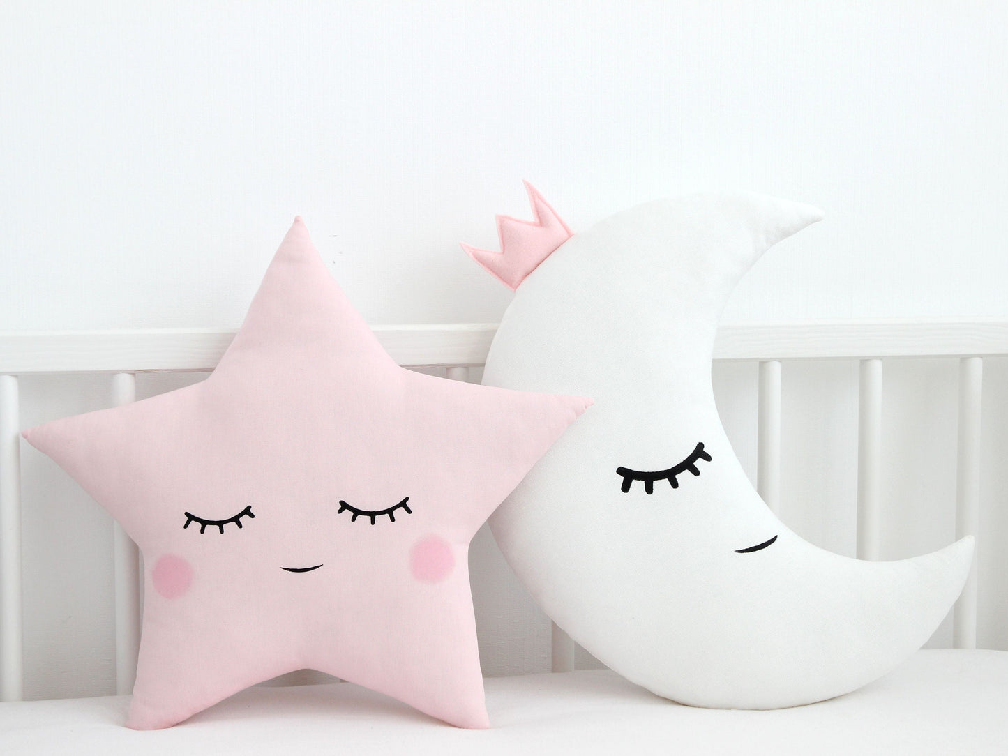 White crescent moon throw pillow, sleepy face; pale pink star throw pillow, sleepy face – baby nursery decor set.
