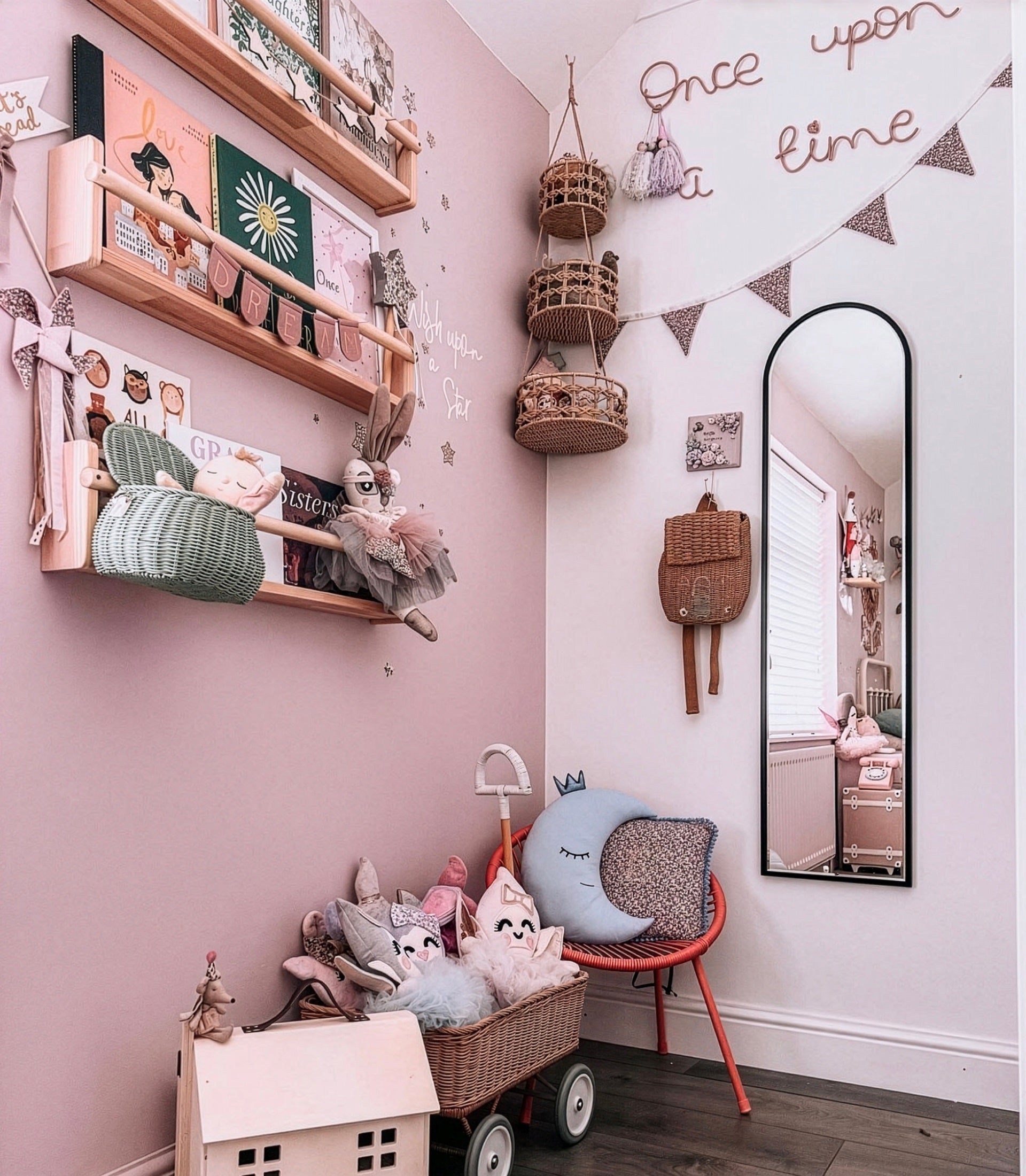 Children's room with pink walls, shelves, and toys.