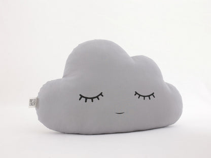 Gray cloud-shaped throw pillow, closed eyes and small smile – on a plain white background.